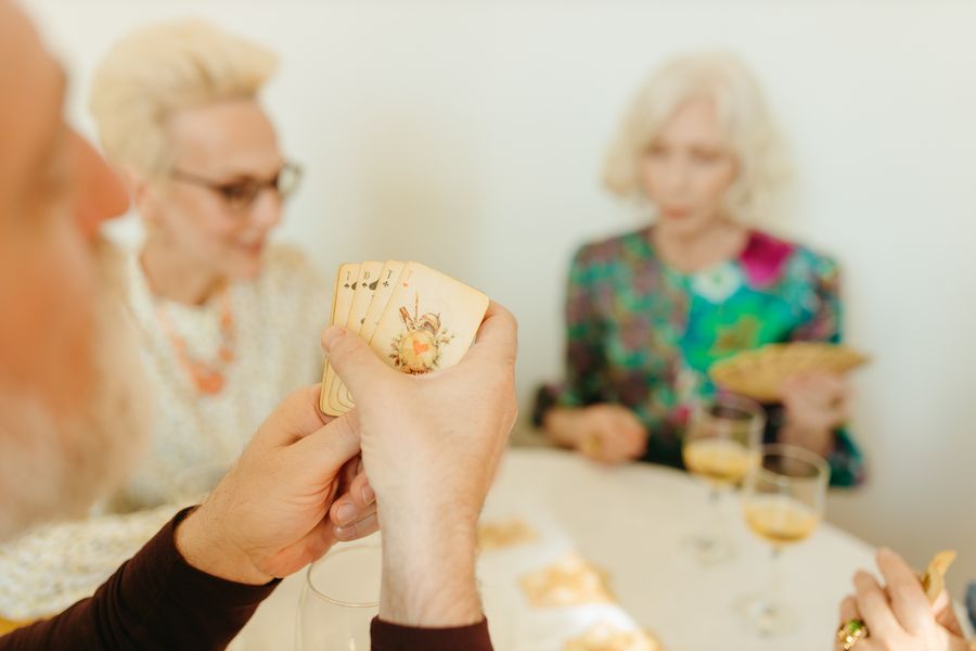 Seniors enjoying a card game together at a table