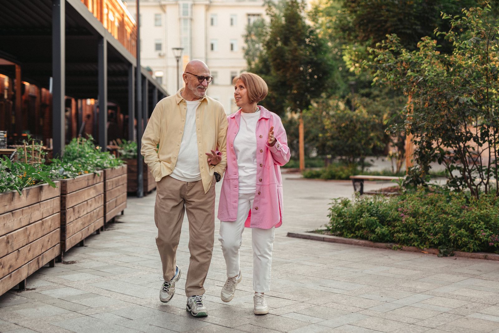 A smiling senior couple walking together outdoors